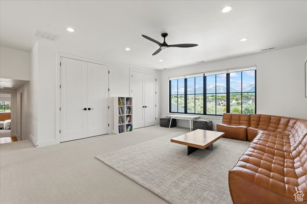 Living room with ceiling fan, recessed lighting, plenty of natural light, and carpet floors