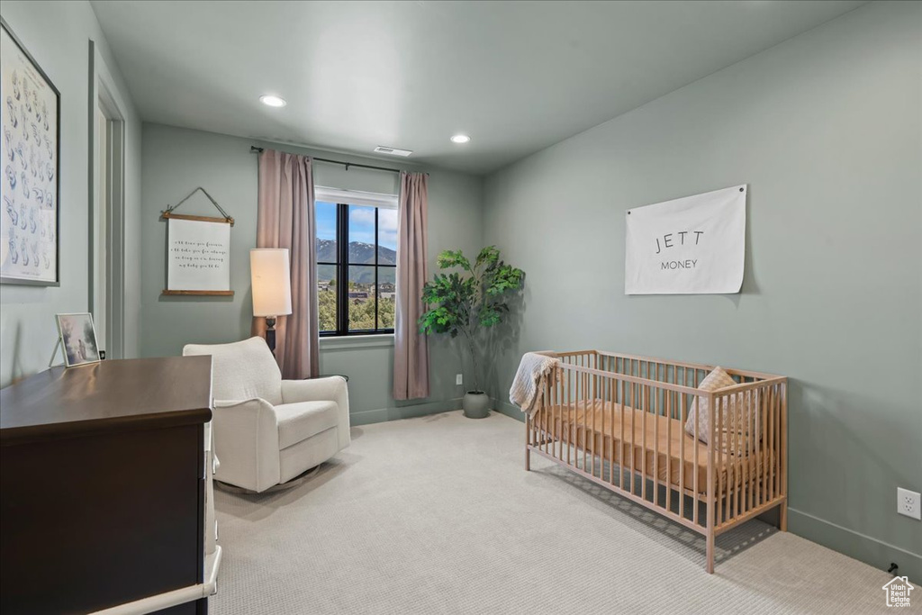 Carpeted bedroom with a crib, baseboards, and recessed lighting