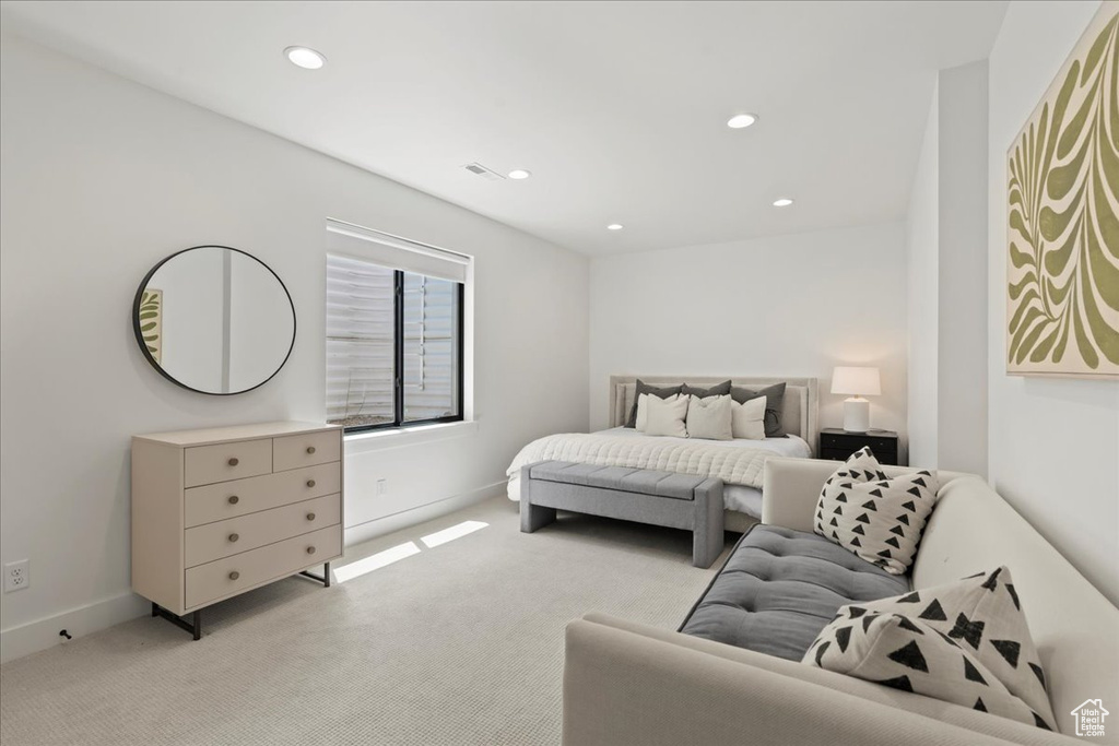 Bedroom with light carpet, recessed lighting, and baseboards