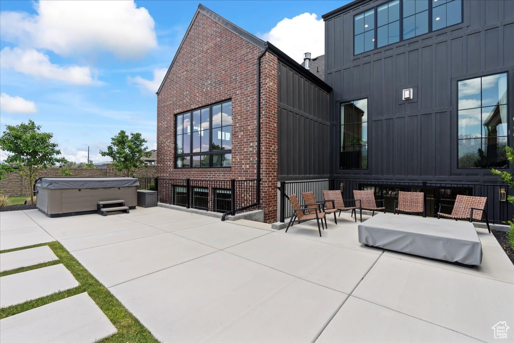 View of patio with a hot tub