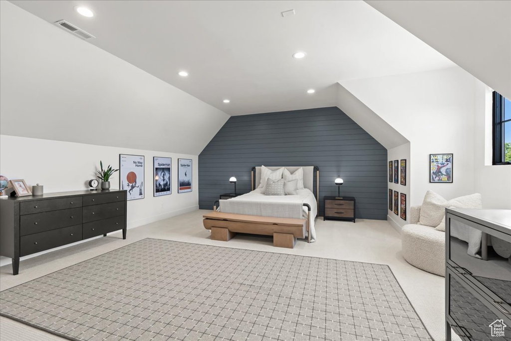 Carpeted bedroom featuring vaulted ceiling, baseboards, recessed lighting, and an accent wall