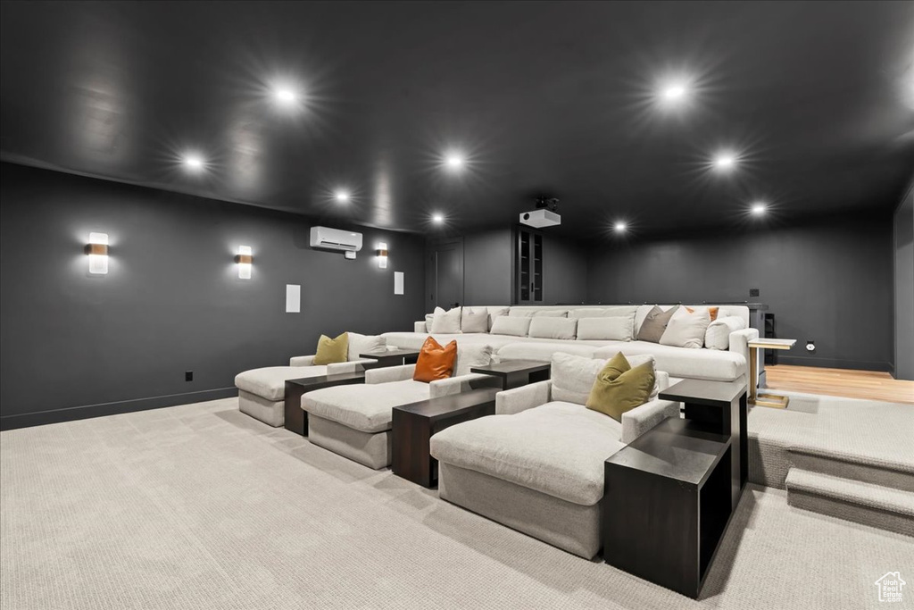 Home theater with recessed lighting, a wall mounted air conditioner, and baseboards