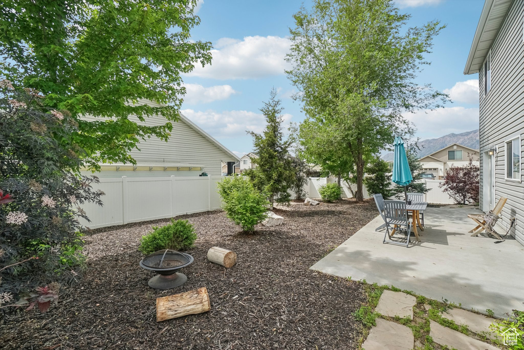 Fenced backyard with a patio