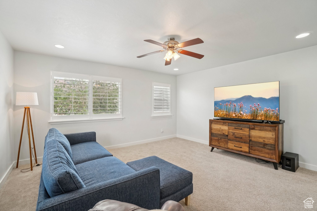 Living area with carpet flooring, ceiling fan, recessed lighting, and baseboards