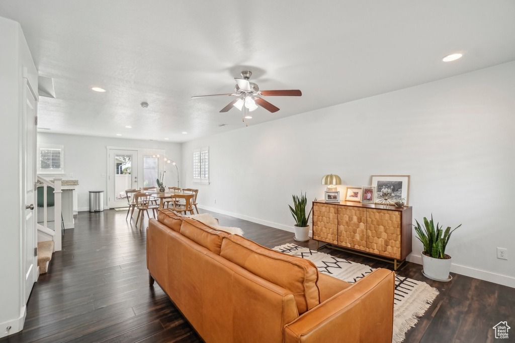 Living area with ceiling fan, baseboards, recessed lighting, and dark wood finished floors