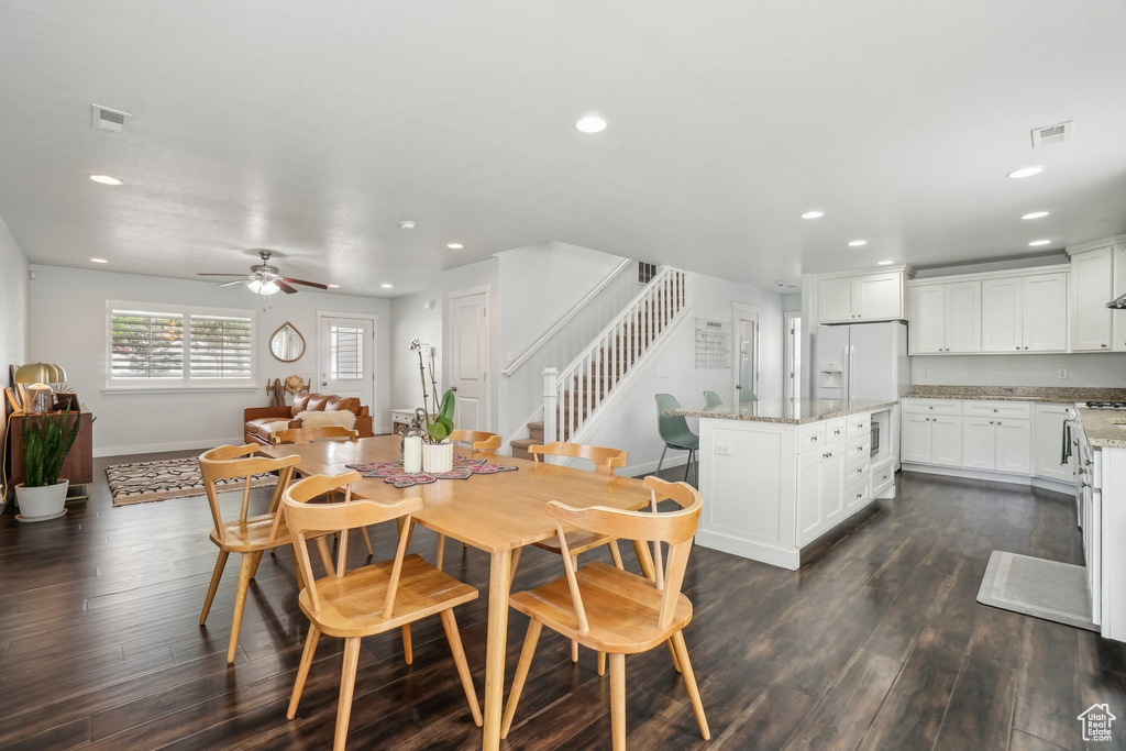Dining space featuring recessed lighting, ceiling fan, stairs, dark wood-style flooring, and baseboards