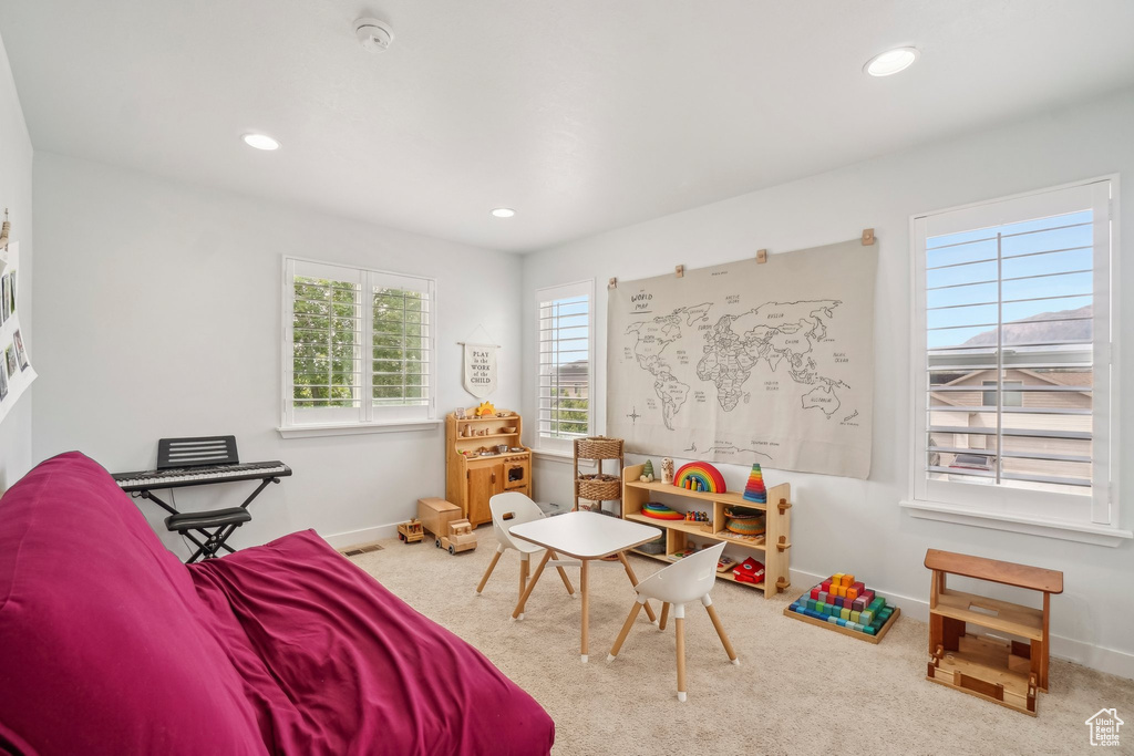 Recreation room featuring baseboards, recessed lighting, and carpet