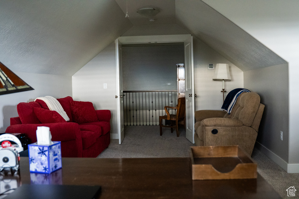 Bonus room with lofted ceiling, carpet flooring, and baseboards