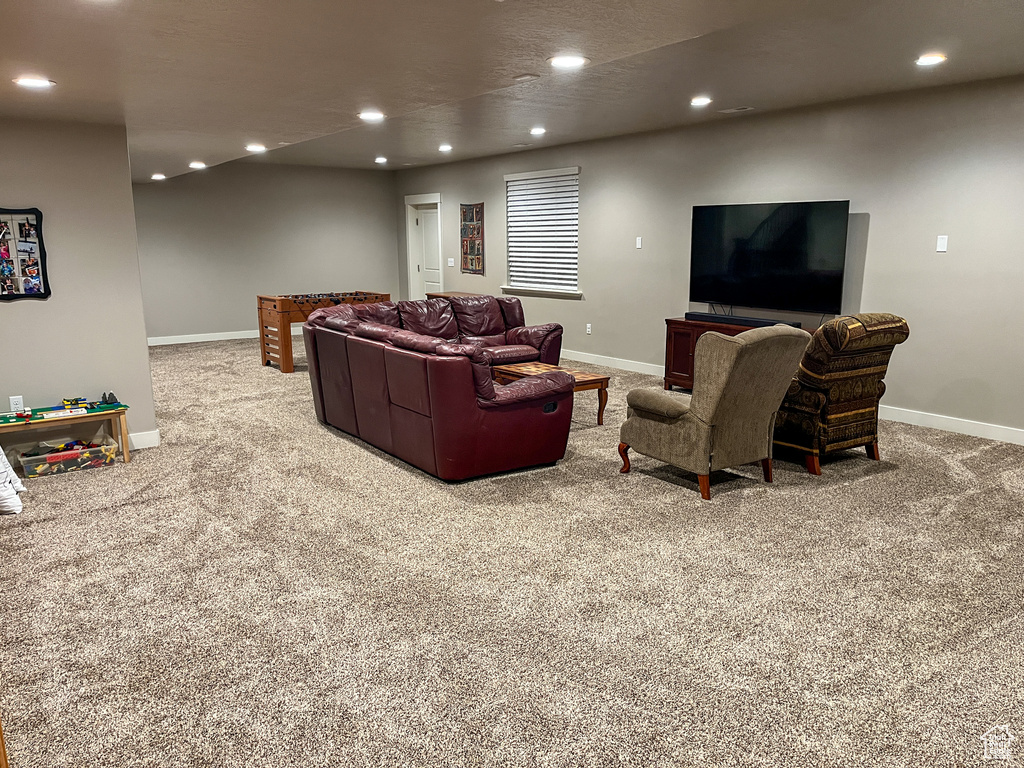 Living room with carpet floors, recessed lighting, and baseboards