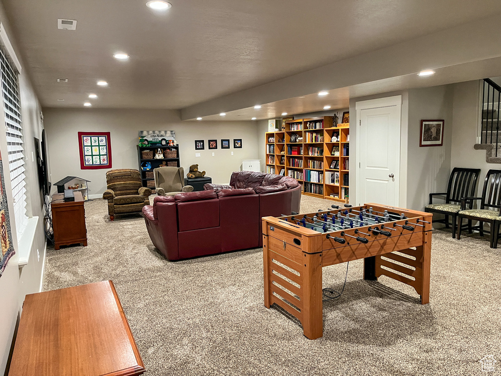 Recreation room with carpet floors and recessed lighting