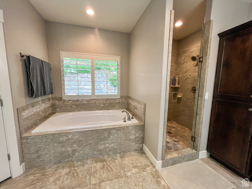 Full bath with a bath, a shower stall, and recessed lighting