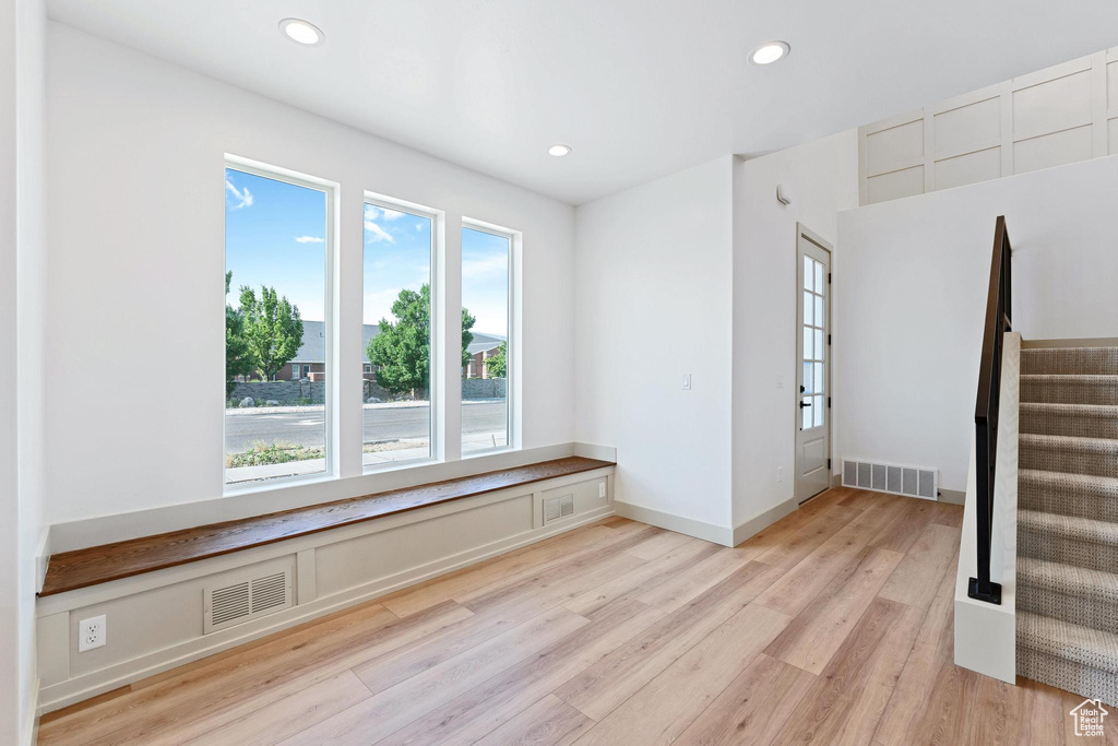 Unfurnished room featuring light wood-type flooring, recessed lighting, and stairway