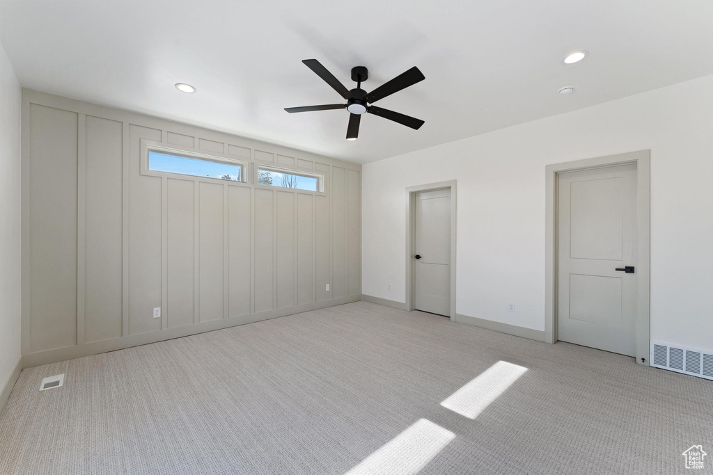 Unfurnished bedroom with light carpet, recessed lighting, baseboards, and ceiling fan