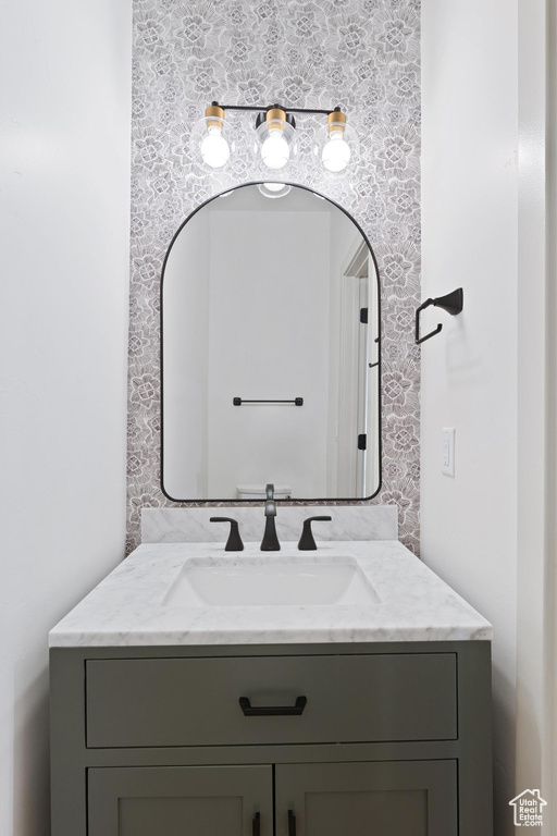 Bathroom featuring vanity and wallpapered walls