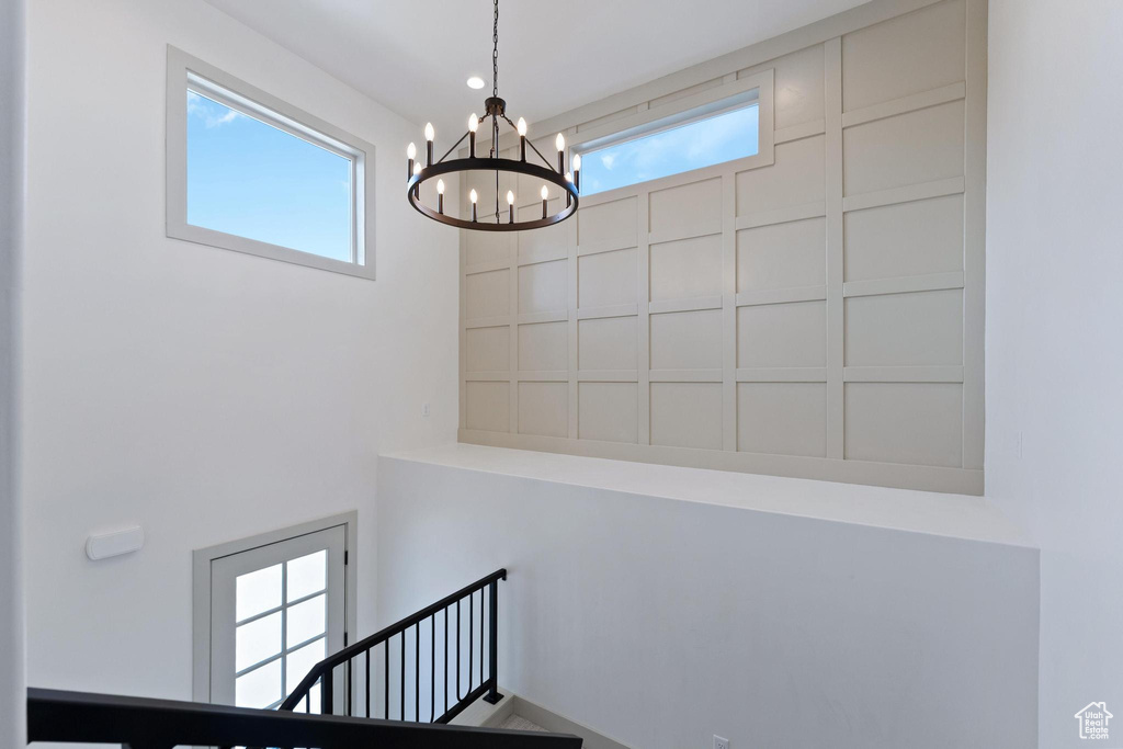 Stairway featuring a chandelier and a high ceiling