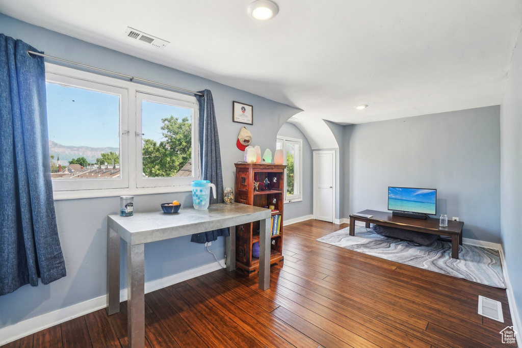 Home office with baseboards and wood finished floors