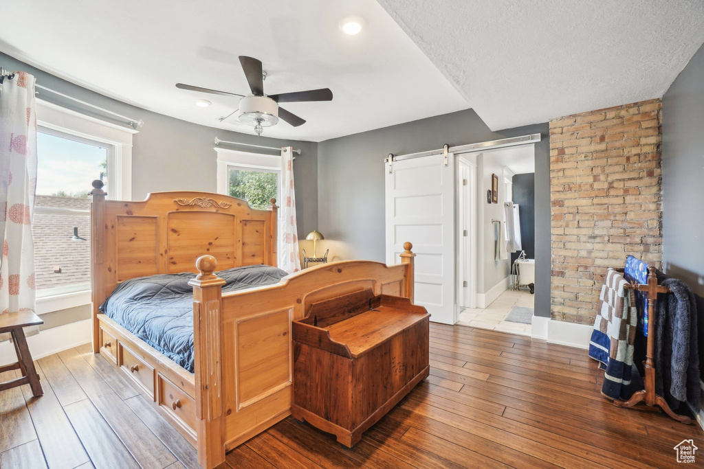 Bedroom with wood-type flooring, baseboards, ceiling fan, connected bathroom, and recessed lighting