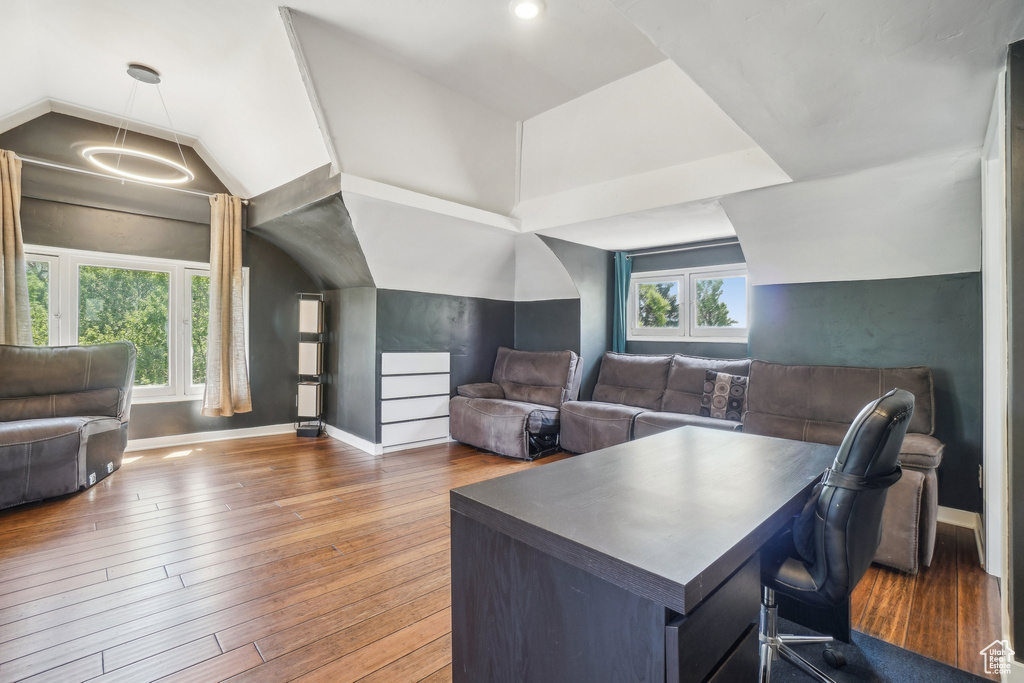 Office area with hardwood / wood-style floors, baseboards, and vaulted ceiling