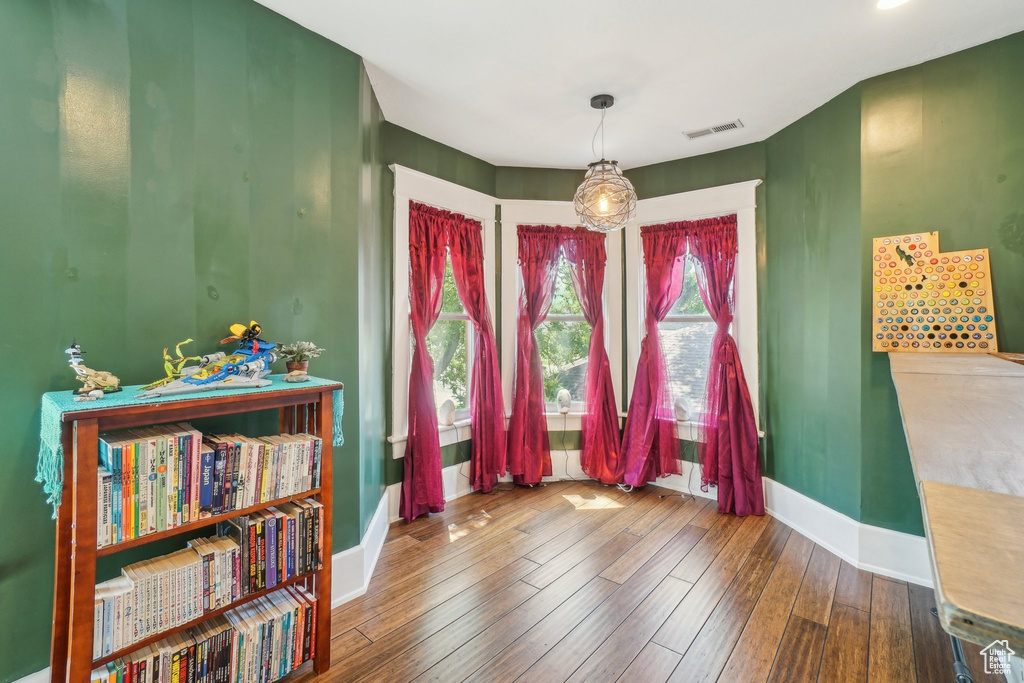 Dining room featuring wood-type flooring and baseboards