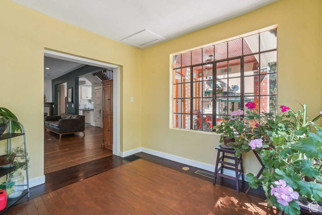 Foyer entrance with baseboards and wood-type flooring