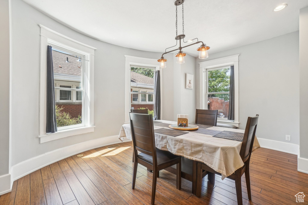 Dining room featuring plenty of natural light, baseboards, hardwood / wood-style floors, and recessed lighting