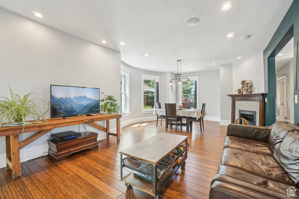 Living area featuring recessed lighting, wood-type flooring, and baseboards