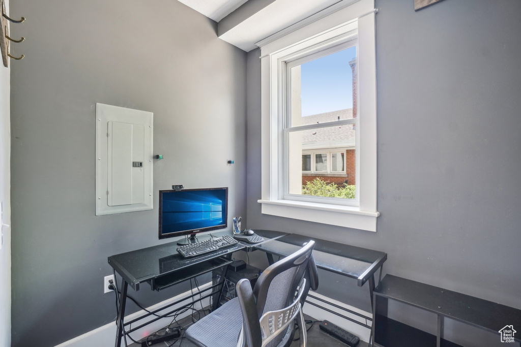 Office area with electric panel and baseboard heating