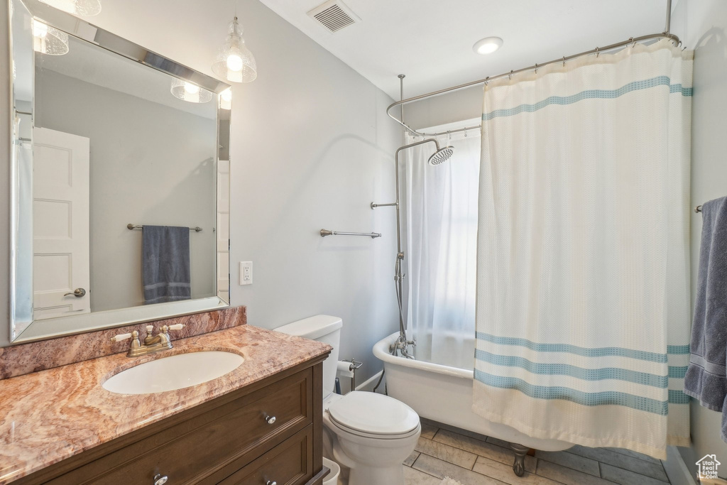 Bathroom with toilet, vanity, and shower / bathtub combination with curtain