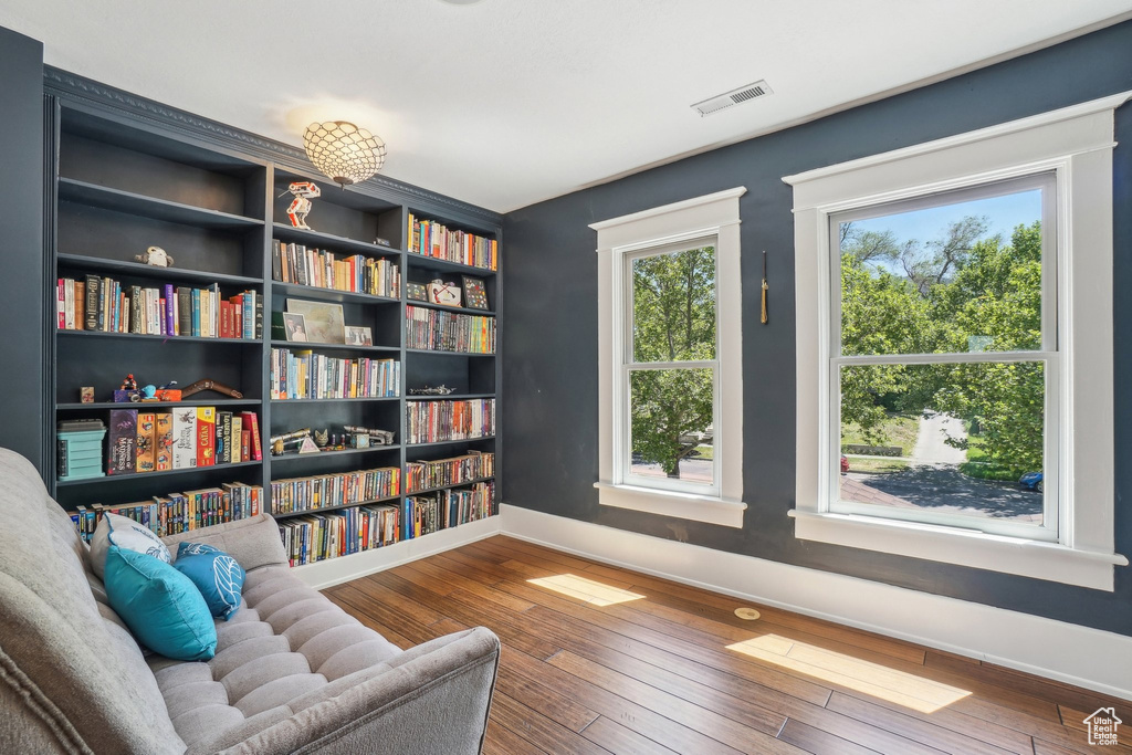 Living area featuring baseboards and wood-type flooring