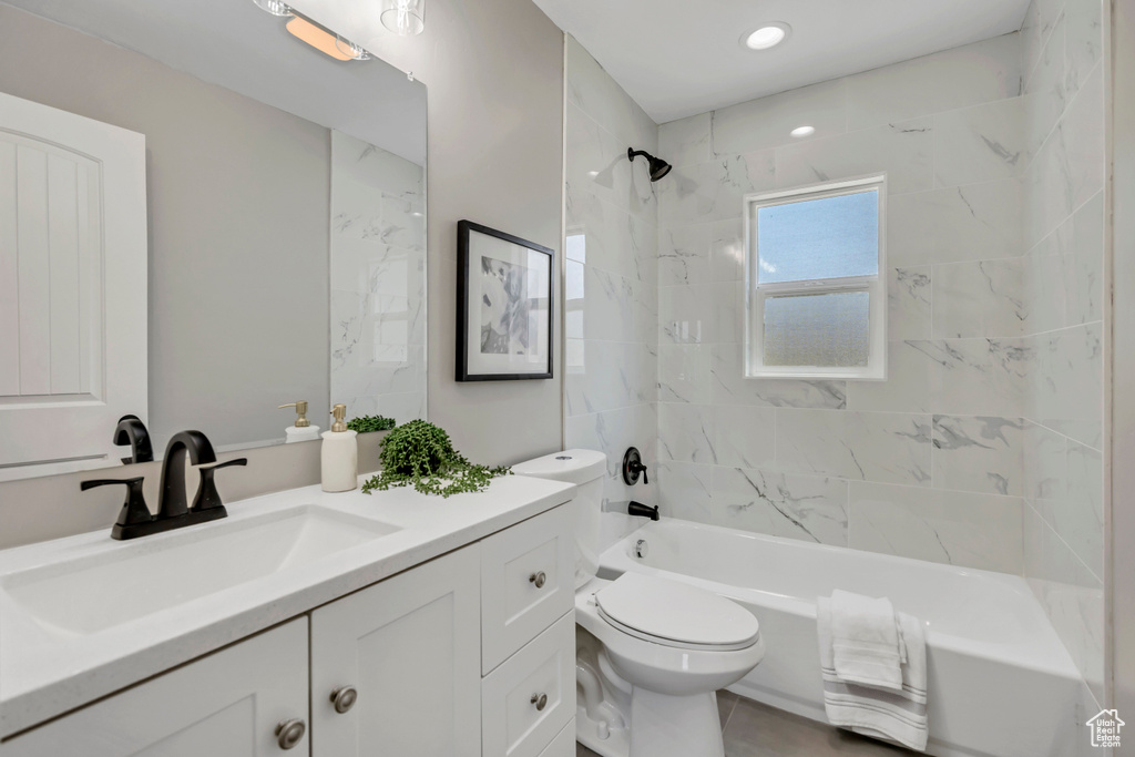 Bathroom featuring vanity, toilet, and bathing tub / shower combination