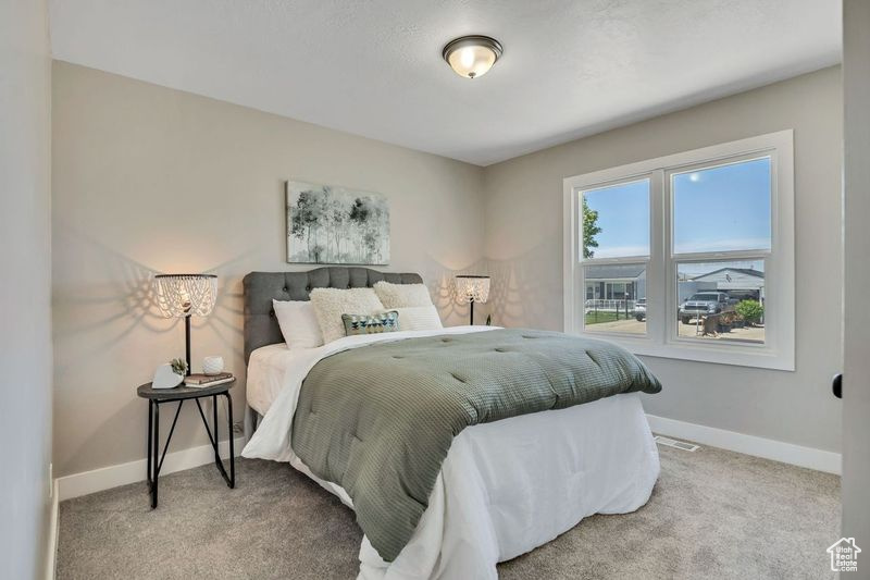 Bedroom featuring baseboards and carpet floors