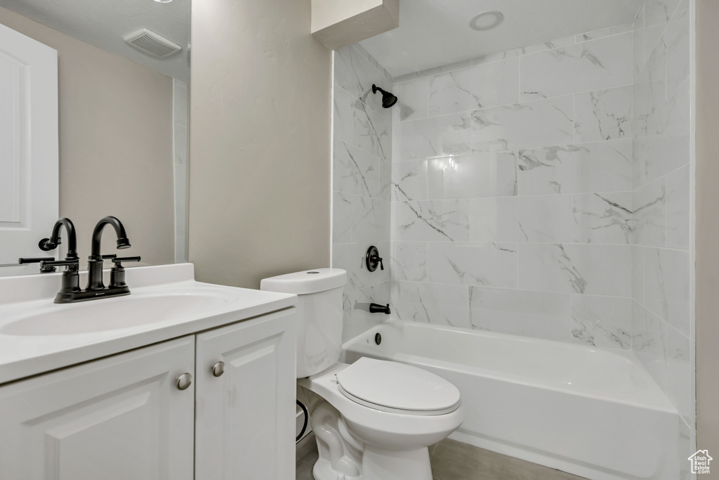 Full bathroom featuring vanity, bathing tub / shower combination, and toilet