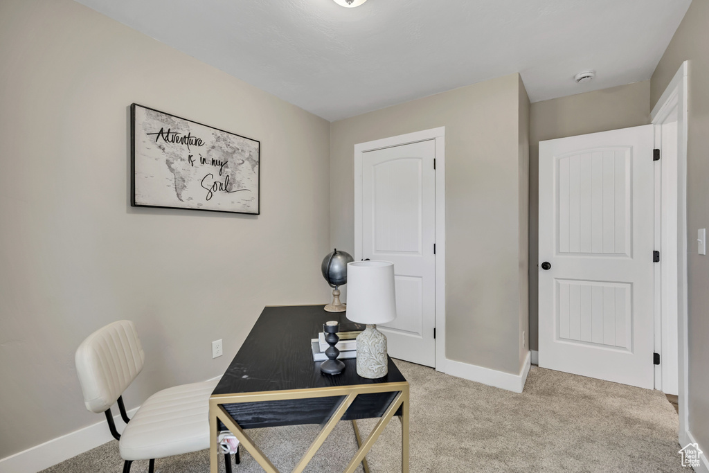 Office space with carpet and baseboards