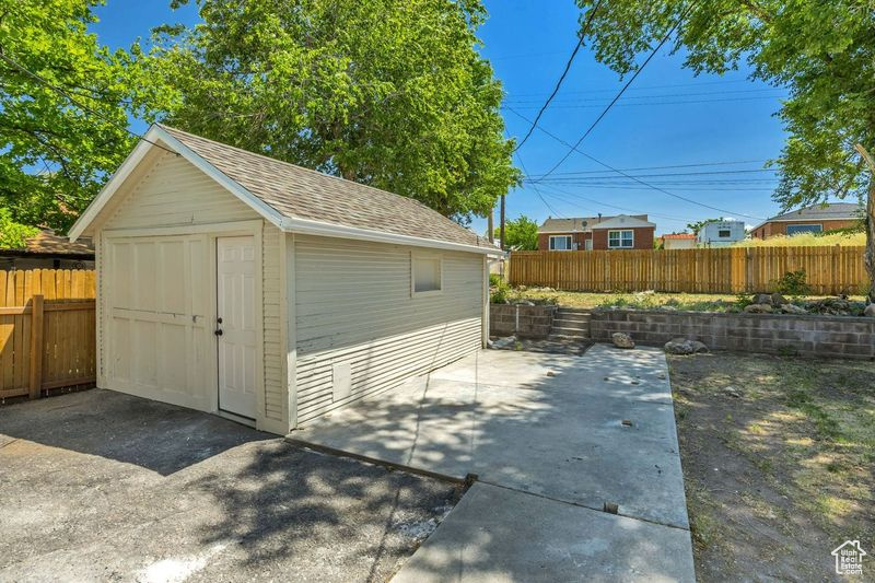 View of shed with a fenced backyard