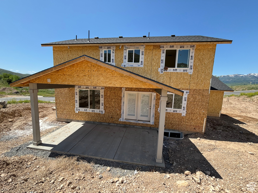 Rear view of property with a patio area and a mountain view