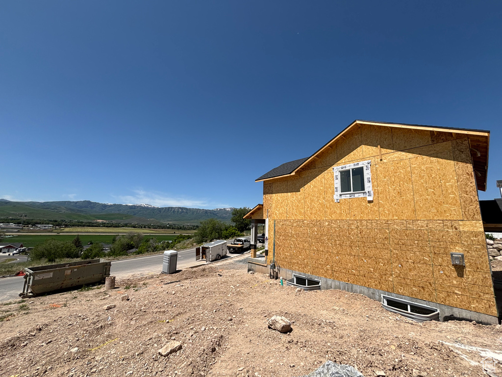 View of side of home featuring a mountain view