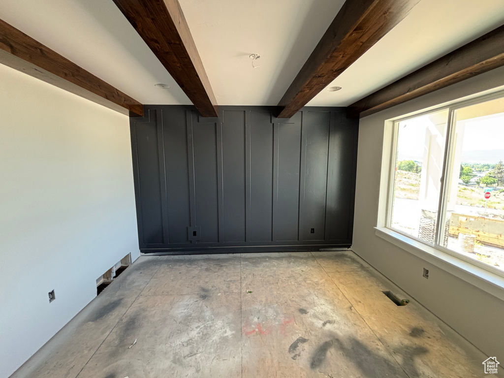 Spare room with beam ceiling