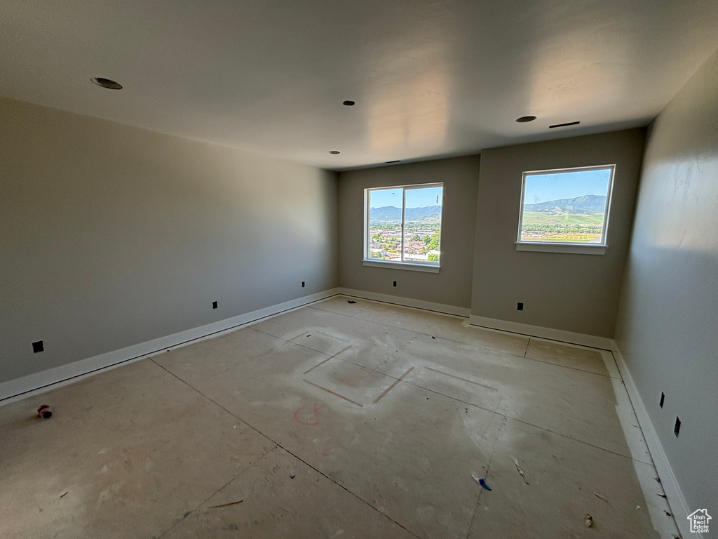 Spare room featuring baseboards