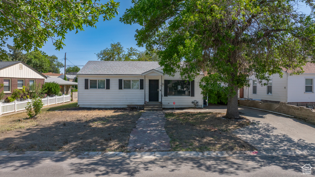 View of front of house featuring entry steps and a shingled roof