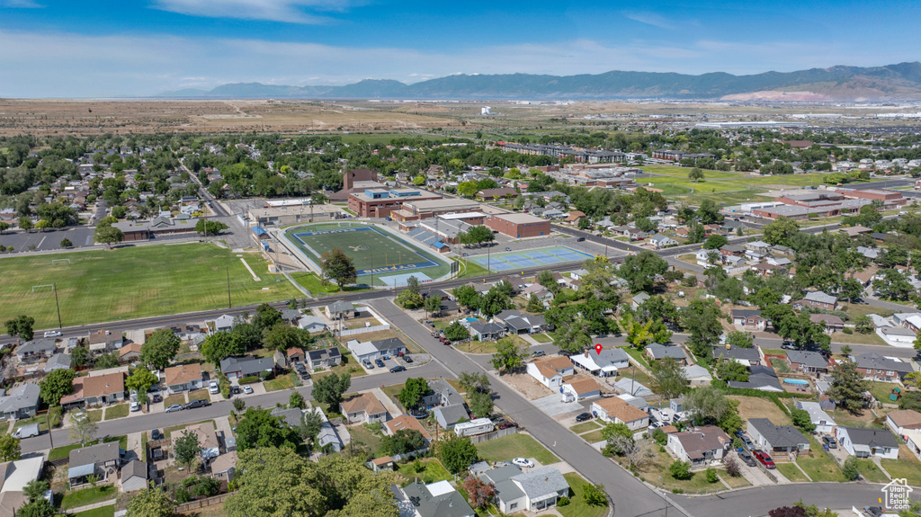 Aerial overview of property\'s location featuring mountains and nearby suburban area