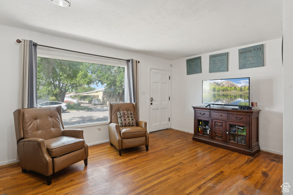 Living area with wood finished floors and baseboards