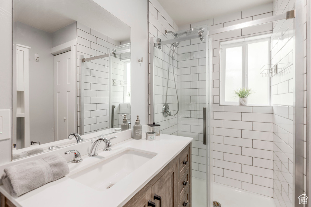 Bathroom featuring a shower stall and vanity