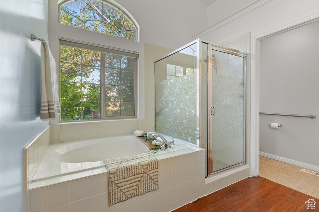 Full bathroom with a garden tub, a shower stall, and tile patterned flooring