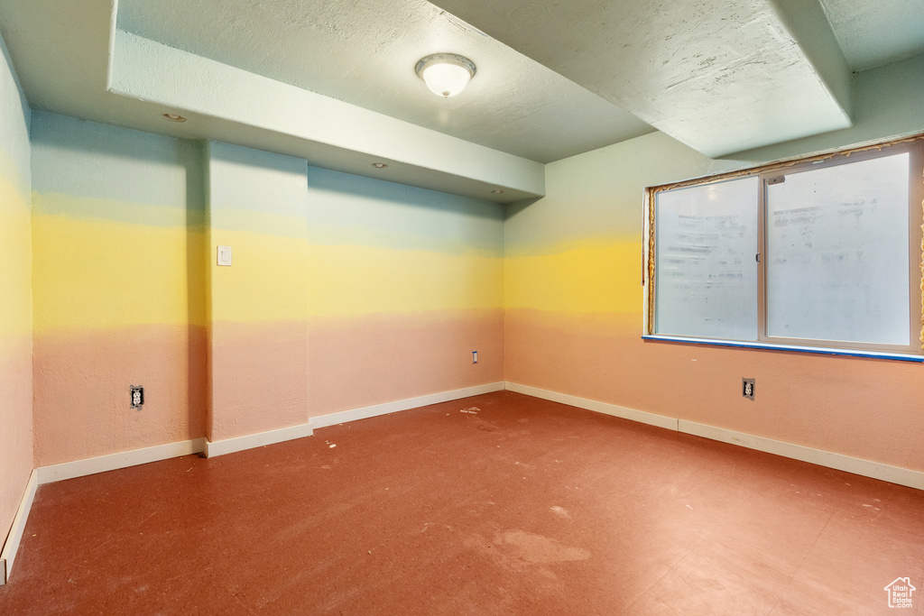 Unfurnished room with baseboards