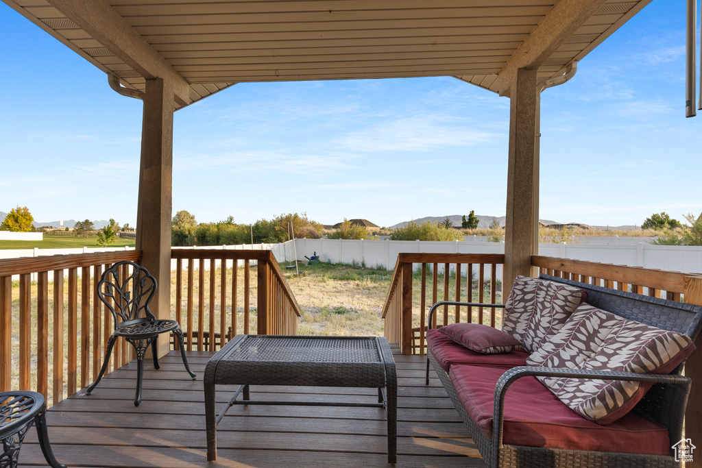 Wooden terrace with a fenced backyard