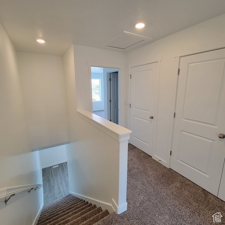 Staircase with carpet and recessed lighting
