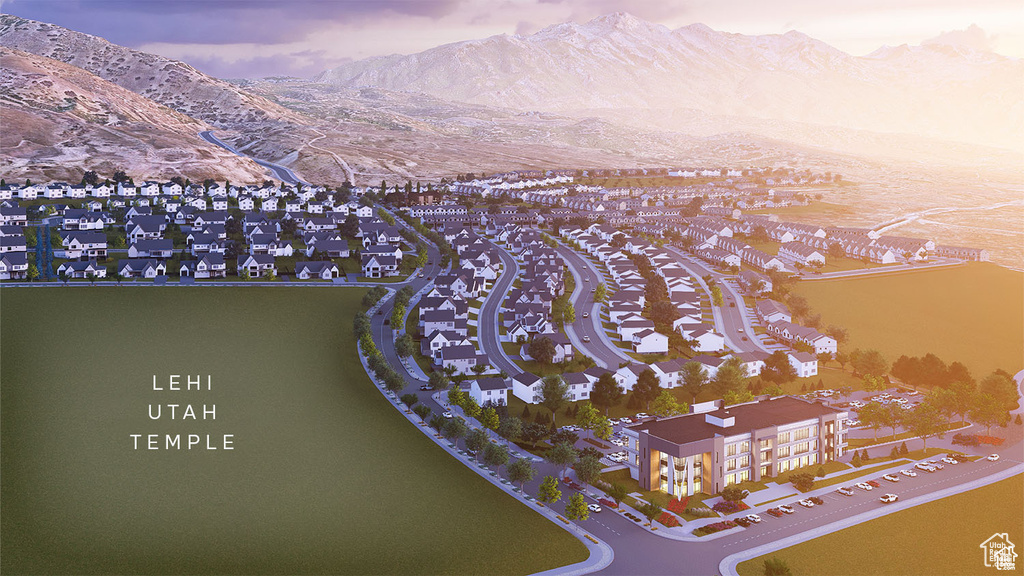 Aerial view of property and surrounding area with a mountain backdrop and nearby suburban area