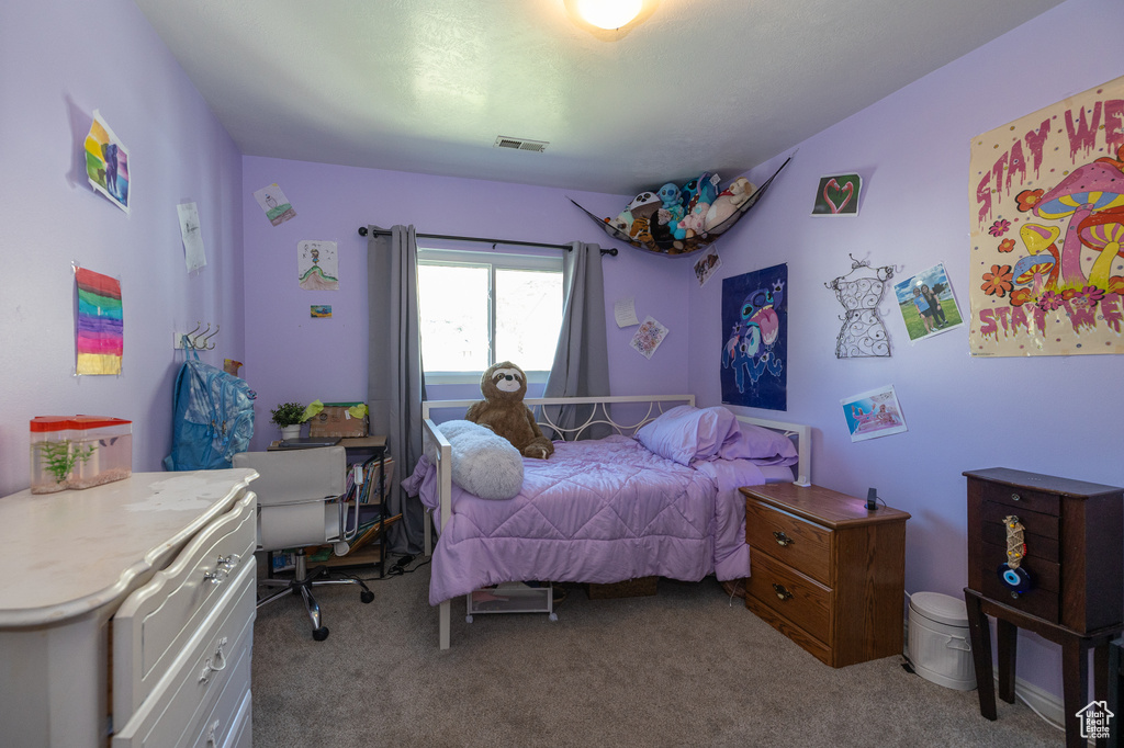 Bedroom featuring light colored carpet