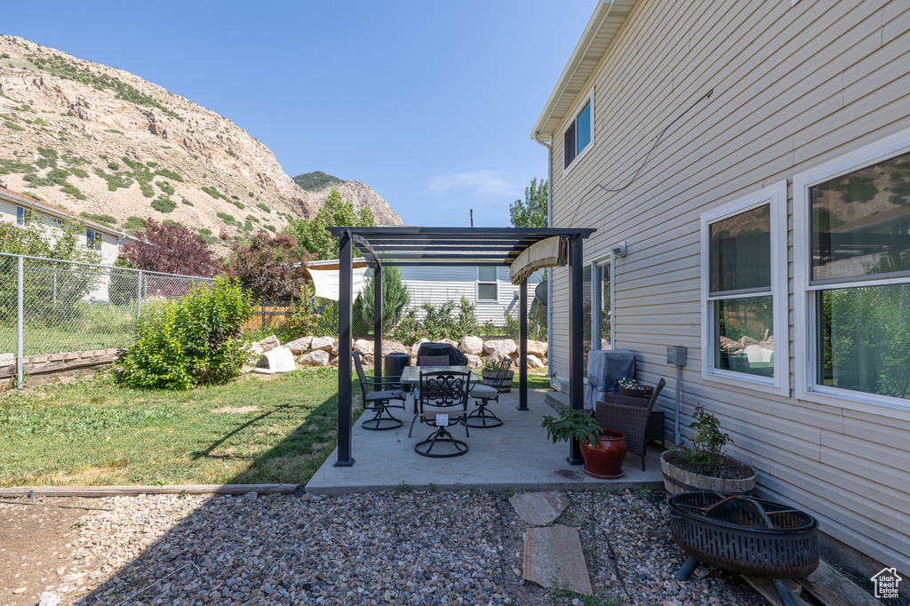 View of yard with a pergola, a mountain view, and a patio area