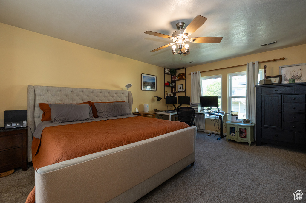 Bedroom with carpet flooring, a desk, and ceiling fan